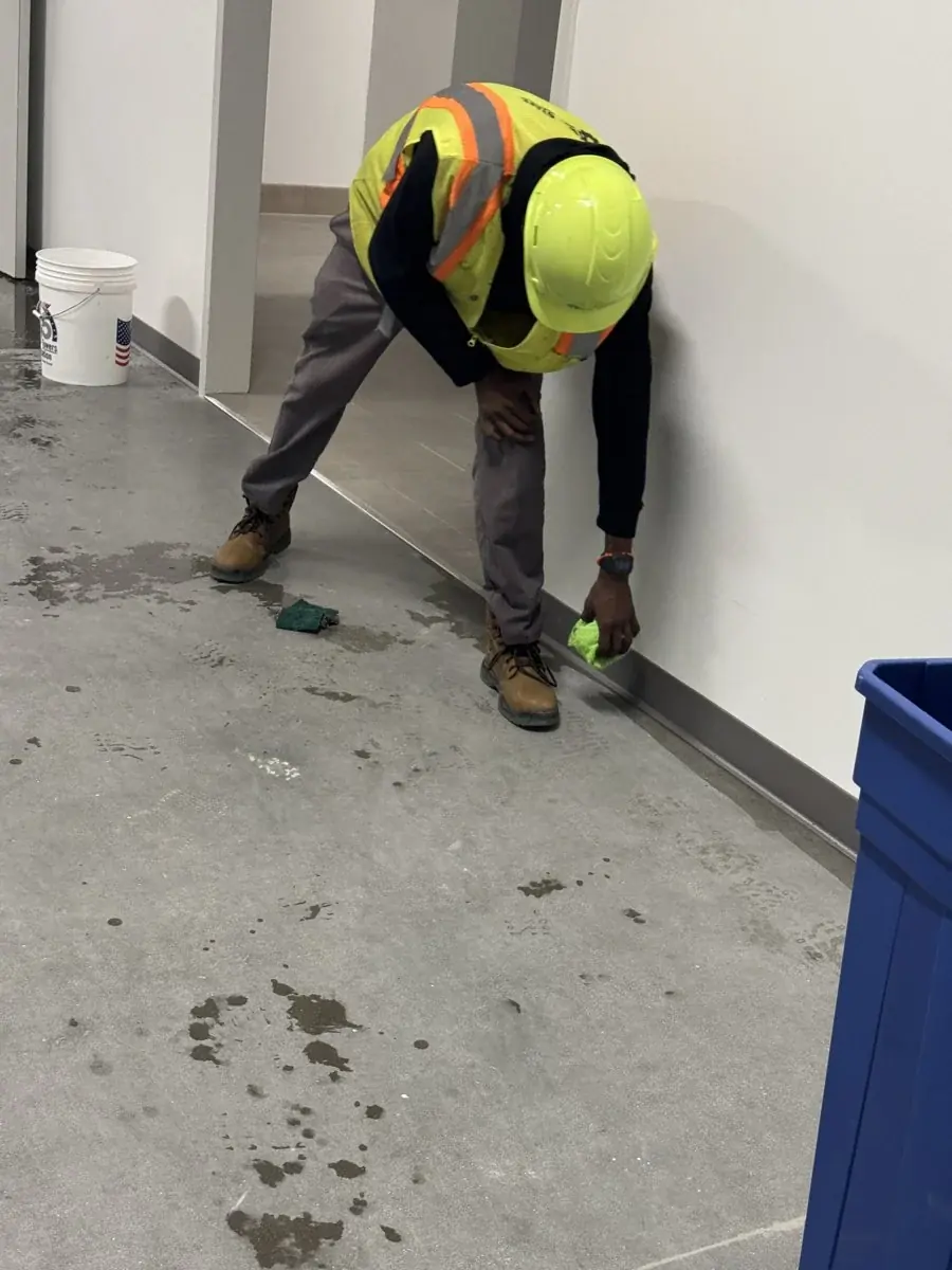 Scrubbing residue along the wall and floor.