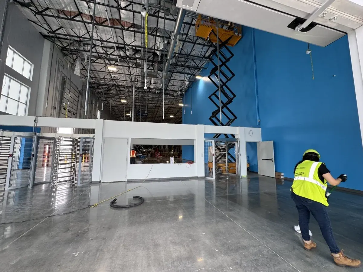 Mopping the floor around a commercial entrance.