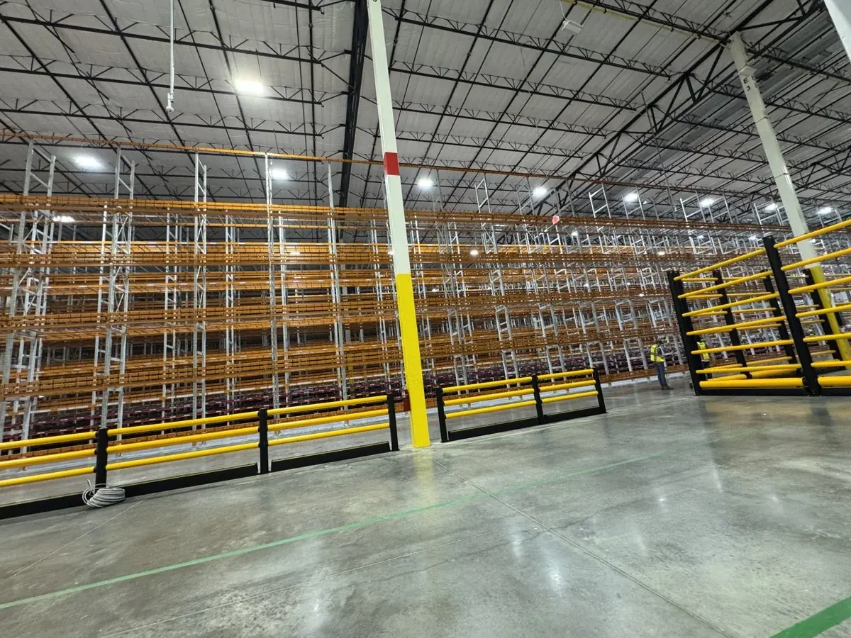 Clean floors between warehouse storage racks.