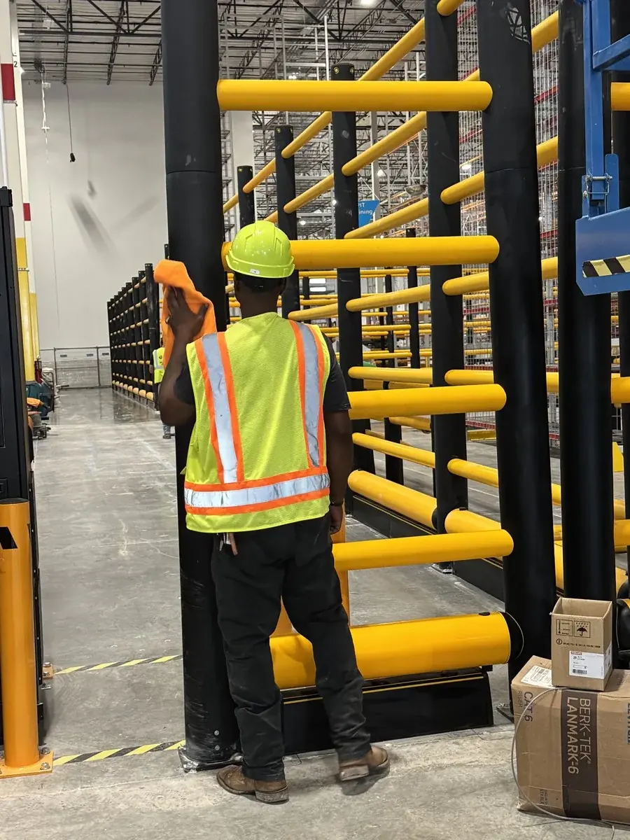 Wiping warehouse rails and fixtures.