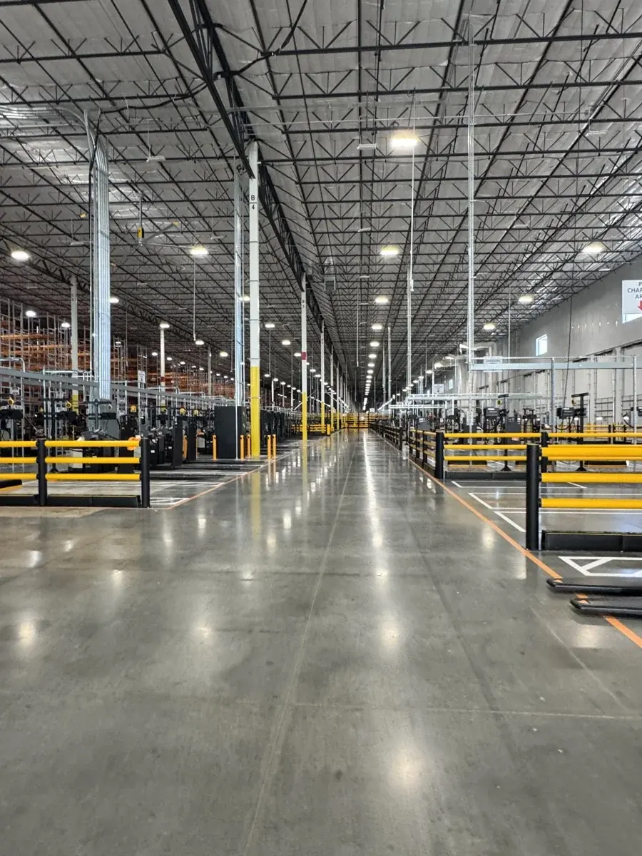 Polished floors across a warehouse aisle.